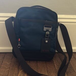 Tumi Blue and Black Messenger Bag with Durable Fabric. 12 “ tall by 9”.